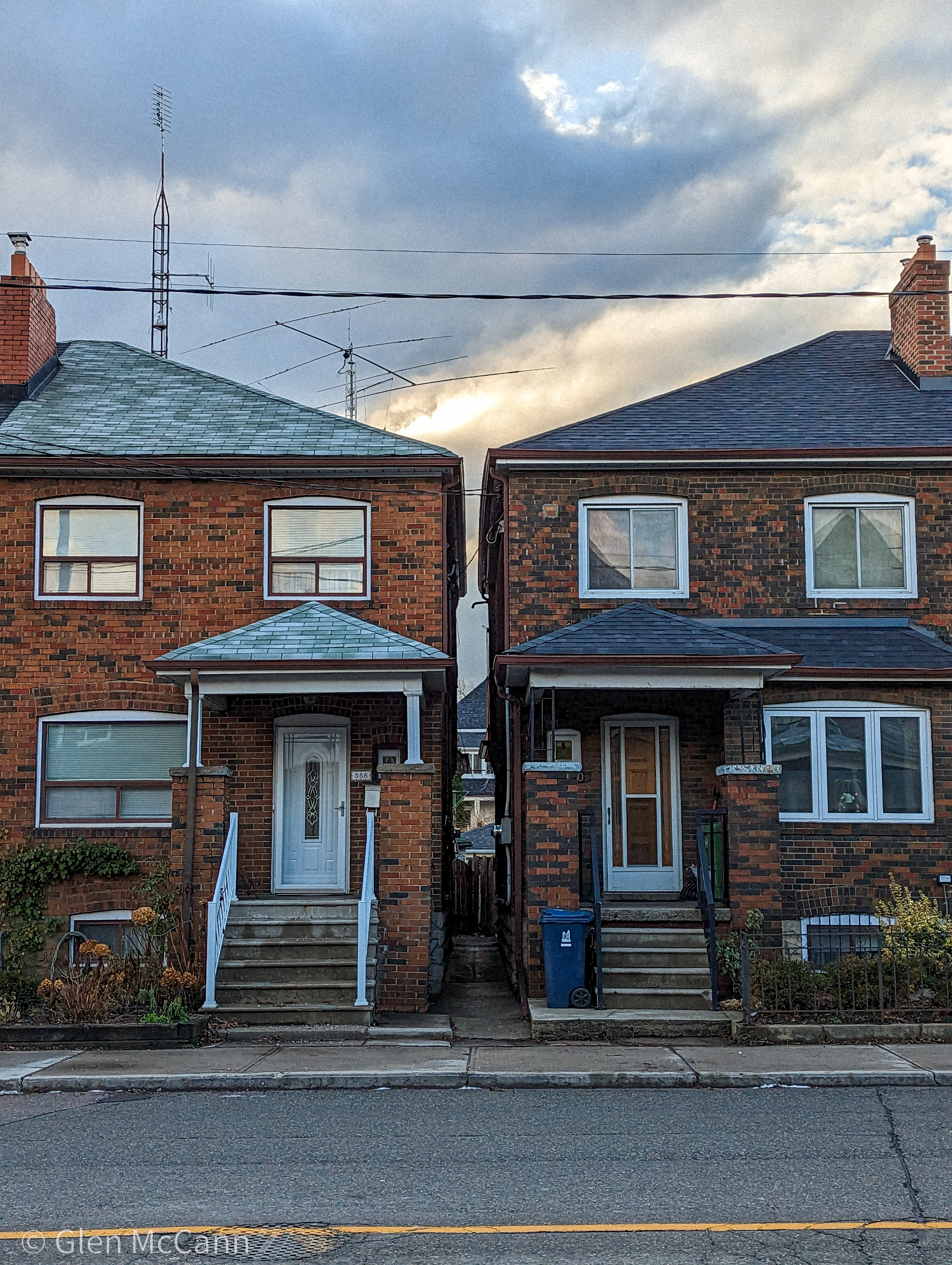 Photo of two very similar houses with a small gap in the middle.